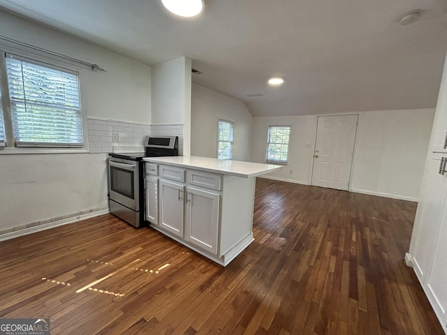 kitchen with dark wood-type flooring, a peninsula, light countertops, stainless steel electric range oven, and vaulted ceiling