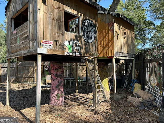 view of outbuilding with an outbuilding and fence