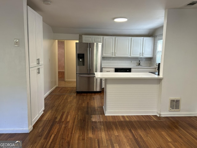 kitchen featuring visible vents, white cabinets, light countertops, and stainless steel fridge with ice dispenser