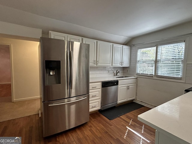 kitchen featuring white cabinets, appliances with stainless steel finishes, light countertops, and a sink