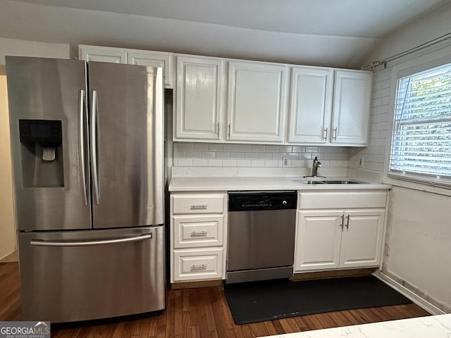 kitchen with appliances with stainless steel finishes, light countertops, and white cabinetry