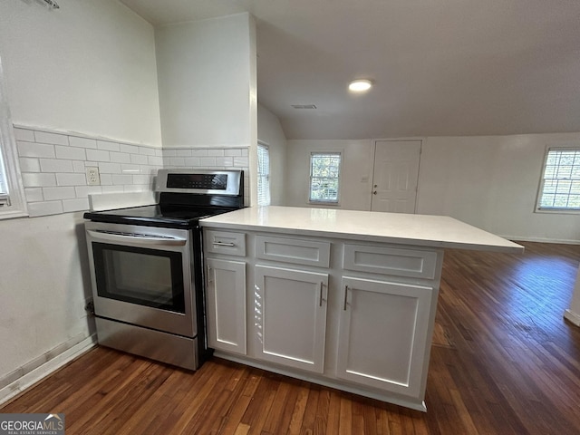 kitchen with tasteful backsplash, dark wood-type flooring, light countertops, a peninsula, and electric stove