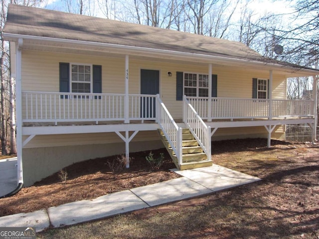 view of front of home featuring a porch and roof with shingles