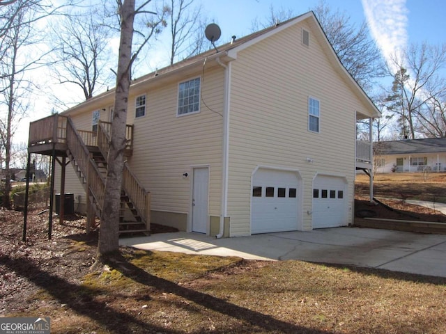 back of house featuring a garage and a wooden deck