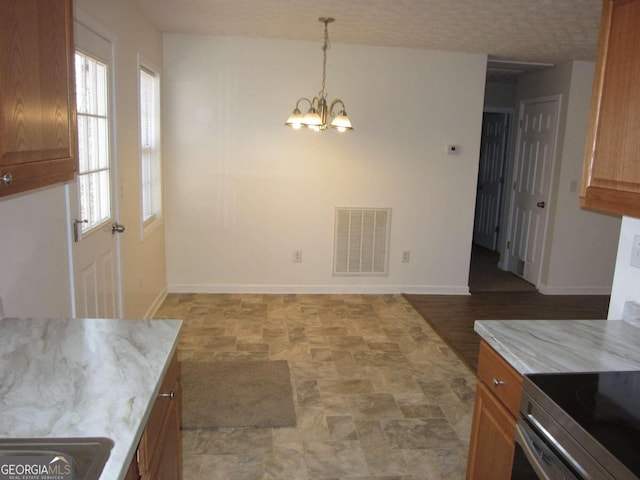 dining area with a notable chandelier and a textured ceiling