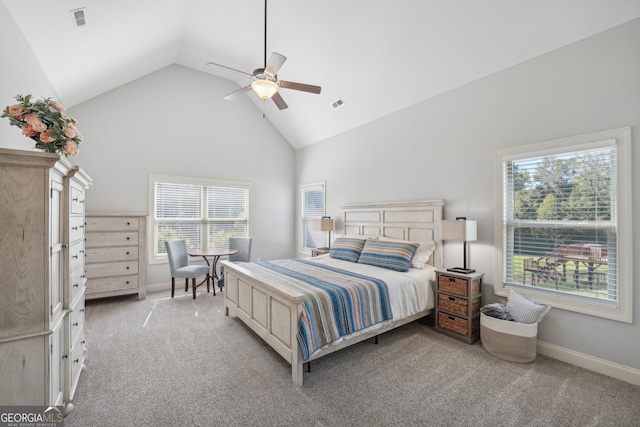 bedroom featuring light carpet, multiple windows, ceiling fan, and high vaulted ceiling