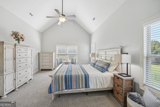 carpeted bedroom featuring high vaulted ceiling and ceiling fan