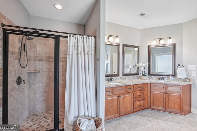 bathroom with walk in shower and vanity