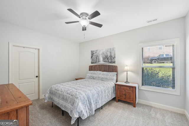 bedroom featuring light carpet and ceiling fan