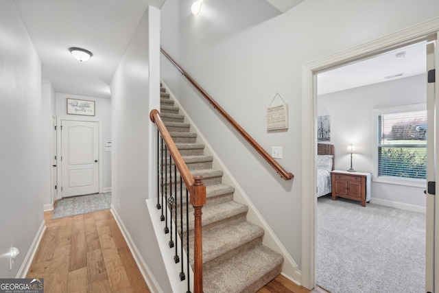 stairway featuring wood-type flooring