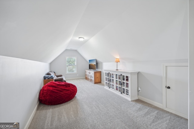 interior space featuring lofted ceiling and light colored carpet