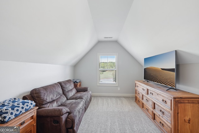 carpeted living room with vaulted ceiling