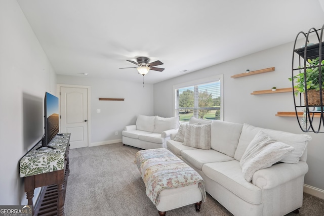 carpeted living room with ceiling fan