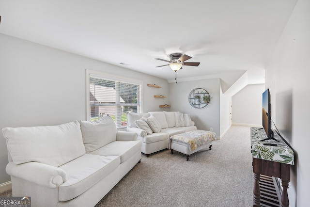 carpeted living room with ceiling fan