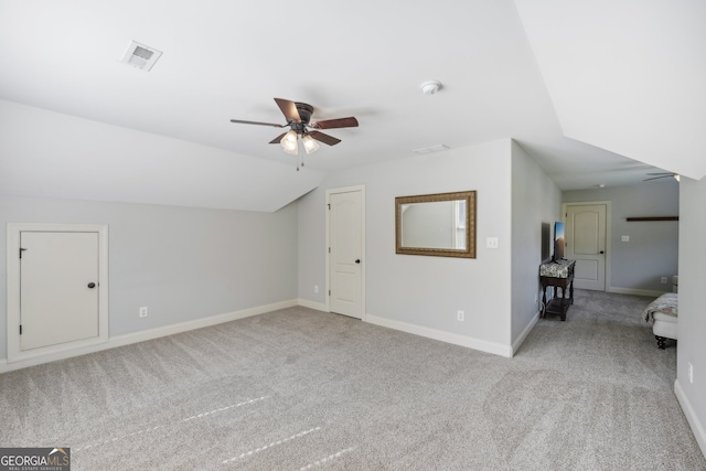 bonus room with light colored carpet, vaulted ceiling, and ceiling fan