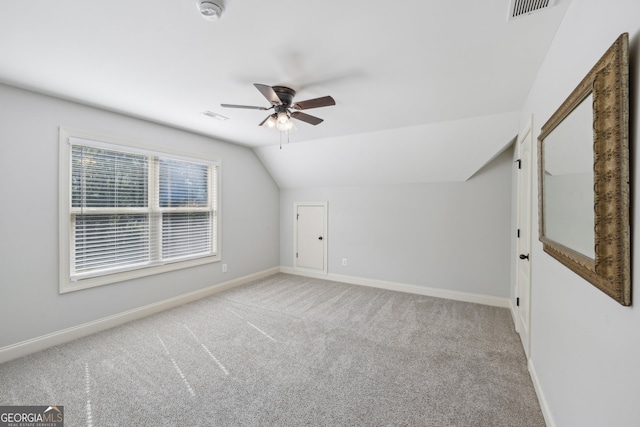 bonus room with ceiling fan, vaulted ceiling, and light carpet