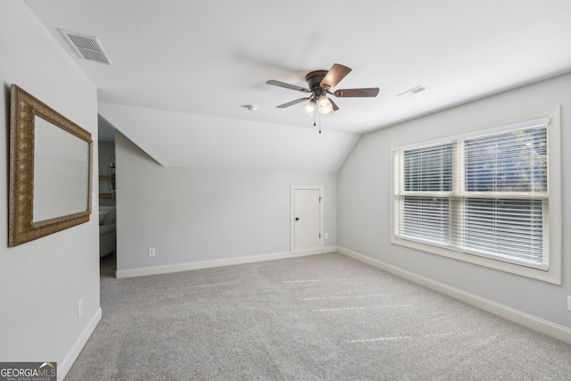 bonus room with lofted ceiling, carpet, and ceiling fan