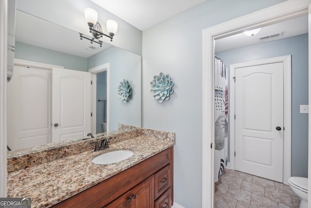 bathroom featuring vanity, walk in shower, and toilet