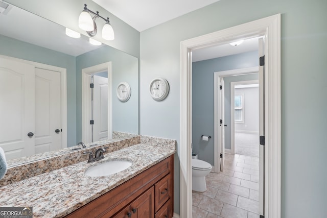 bathroom with tile patterned floors, vanity, and toilet