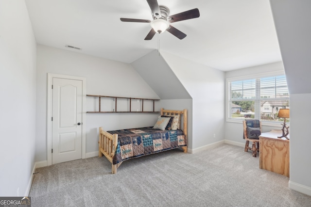 carpeted bedroom with vaulted ceiling and ceiling fan