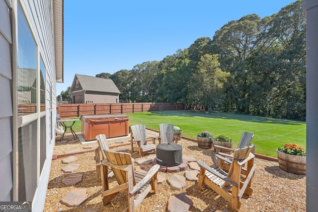 view of patio / terrace featuring an outdoor fire pit and a hot tub