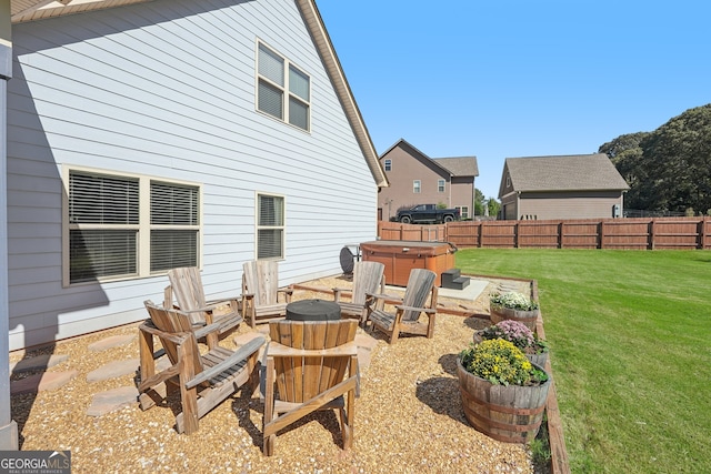 view of patio / terrace with a hot tub and a fire pit