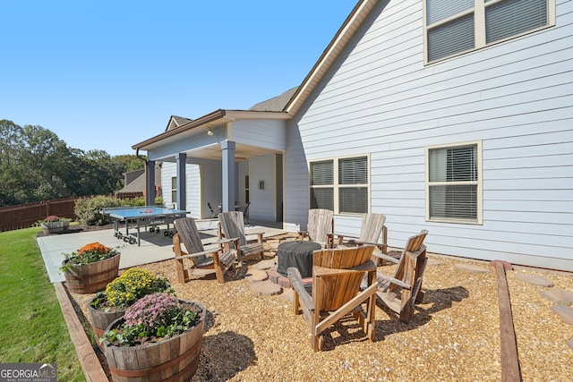 back of property featuring a patio and a fire pit