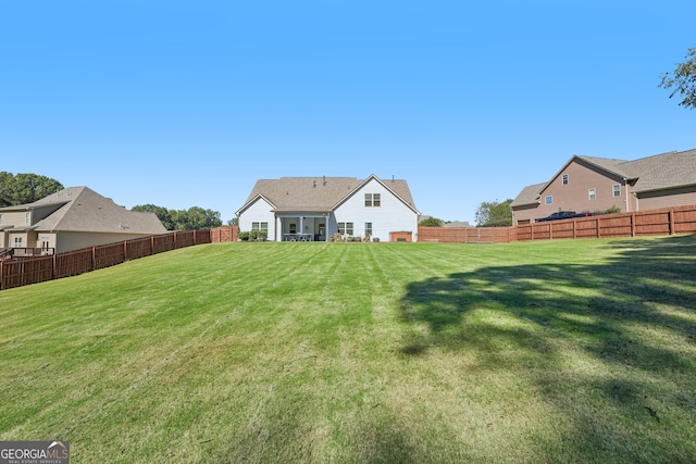 back of property featuring a lawn