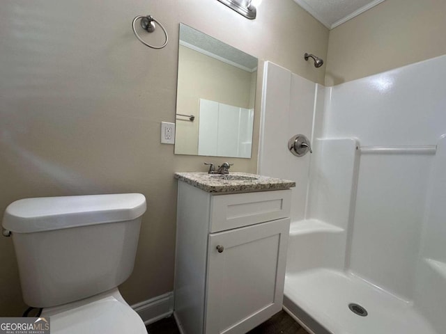 bathroom with vanity, walk in shower, and toilet