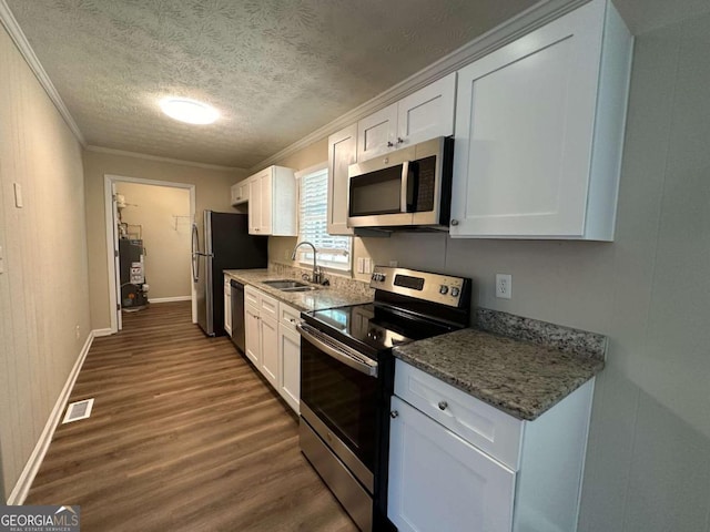 kitchen featuring appliances with stainless steel finishes, dark wood-type flooring, sink, and white cabinetry