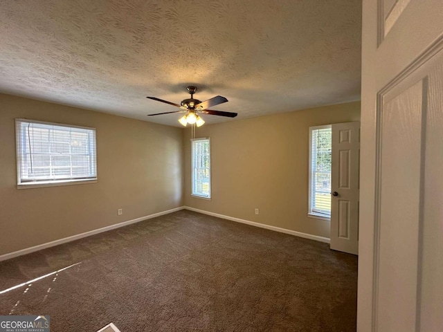 carpeted empty room with ceiling fan and a textured ceiling