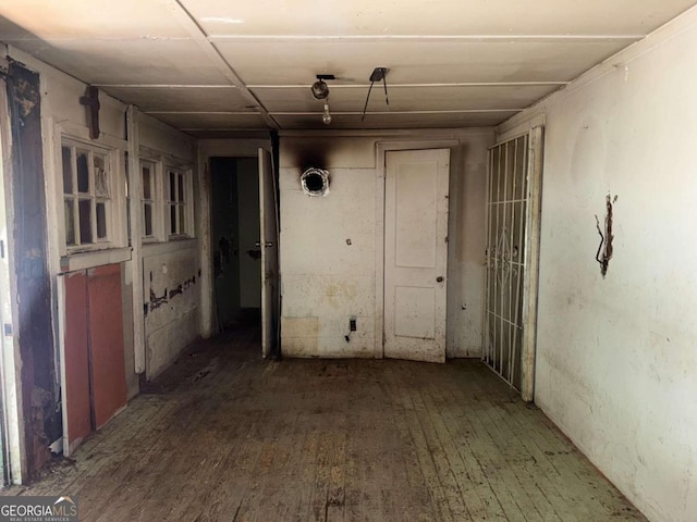 corridor with dark hardwood / wood-style flooring