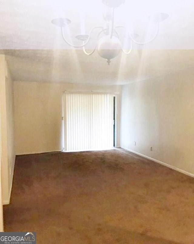 unfurnished room featuring carpet flooring