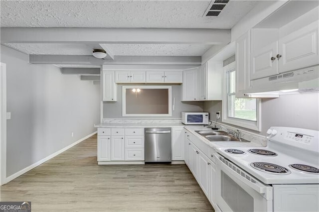 kitchen featuring white appliances, white cabinetry, light hardwood / wood-style flooring, beam ceiling, and a textured ceiling