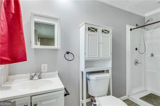 bathroom with walk in shower, vanity, toilet, and a textured ceiling