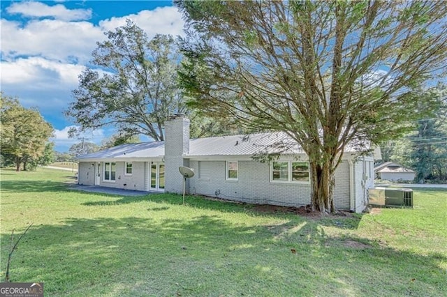 rear view of property featuring a yard