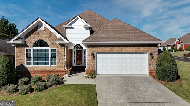 view of front of house with a garage and a front lawn