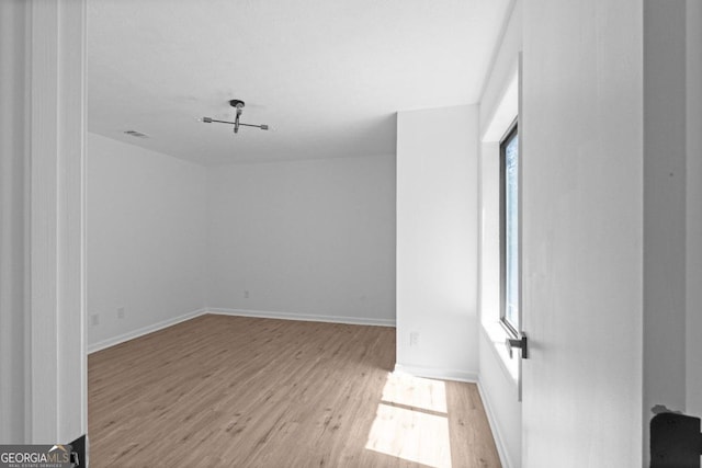 unfurnished room with a wealth of natural light and light hardwood / wood-style flooring