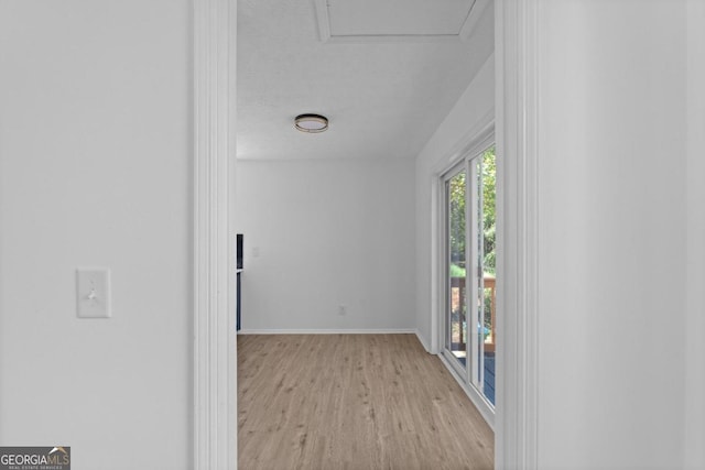 empty room featuring light wood-type flooring and a textured ceiling