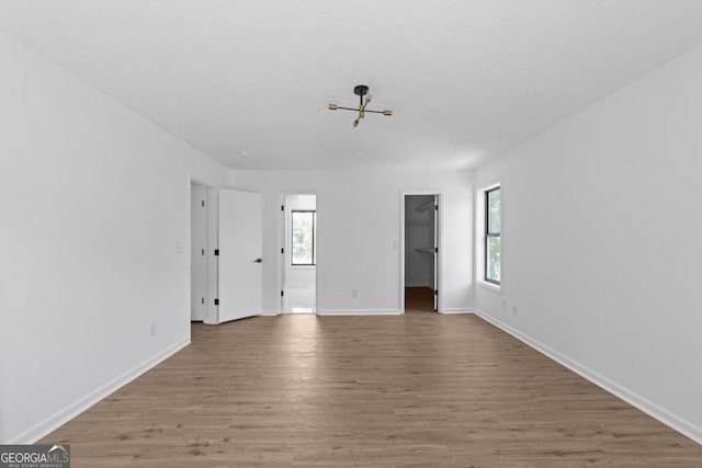 empty room with plenty of natural light and wood-type flooring