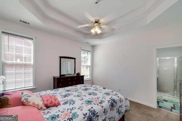 bedroom with carpet flooring, ceiling fan, and a raised ceiling