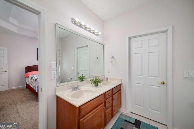 bathroom featuring tile patterned floors, vanity, and a textured ceiling