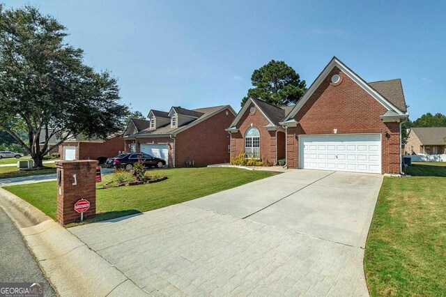 view of front of house with a front yard and a garage