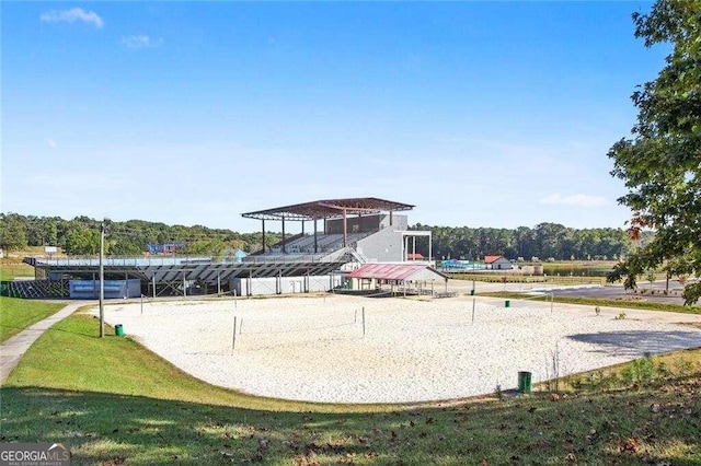 view of community featuring volleyball court and a yard