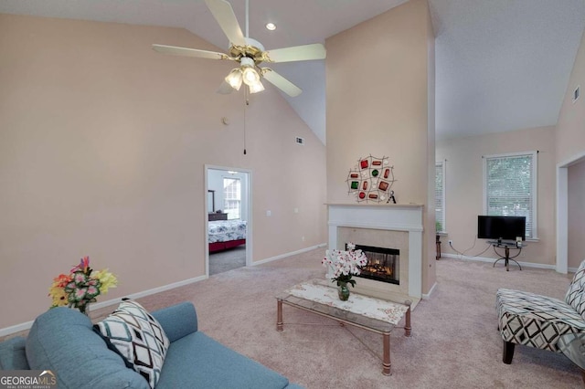 carpeted living room featuring ceiling fan and high vaulted ceiling