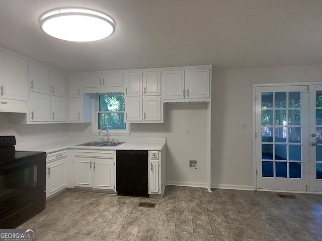 kitchen with extractor fan, black appliances, white cabinetry, and sink