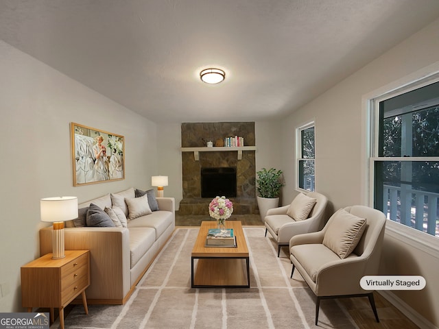 living room with a fireplace and a wealth of natural light