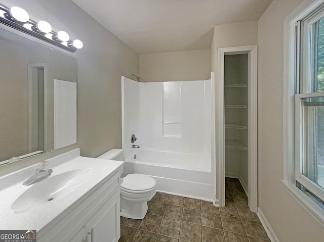 full bathroom with vanity, a textured ceiling, shower / washtub combination, tile patterned floors, and toilet