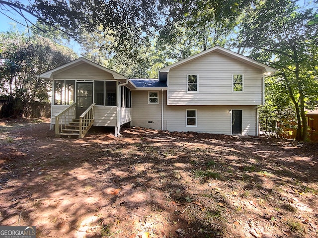 rear view of property featuring a sunroom