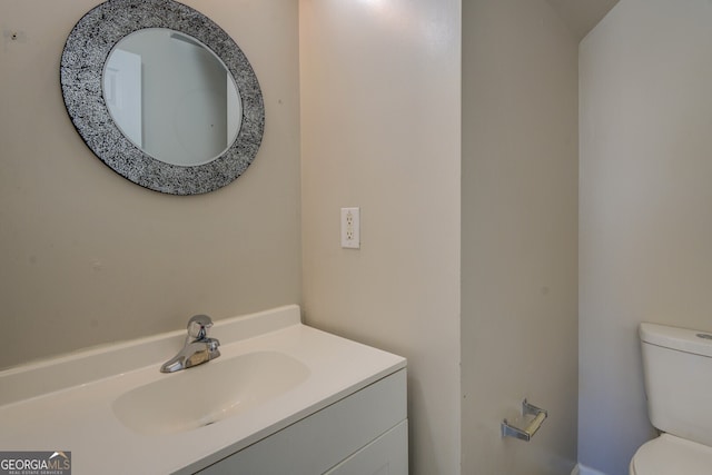 bathroom featuring vanity and toilet